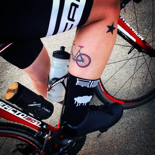 Male With Small Bicycle Tattoo On Legs
