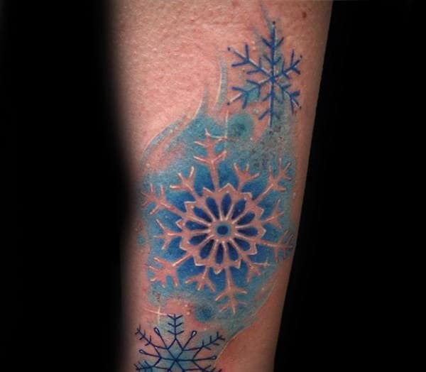 Male With Snowflake Negative Space Watercolor Blue Ink Tattoo On Forearm