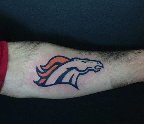 Male With Tattoo Of Football Logo Denver Broncos On Arm