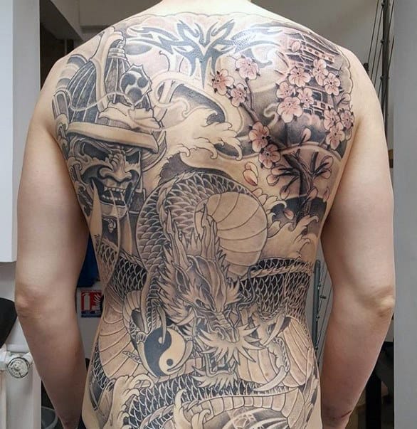 Male With Tattoo Of Samuari And Dragon On Back