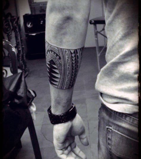 Male With Tattoo On Forearm With Tribal Design
