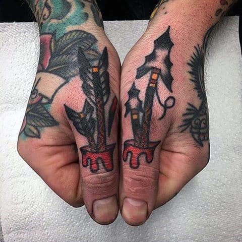 Male With Thumb Tattoos Of Arrows And Arrowheads