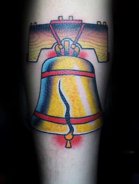Male With Traditional Liberty Bell Tattoo On Inner Forearm