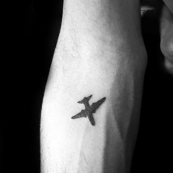 Male With Travel Themed Tattoos Small Airplane Design On Inner Forearm