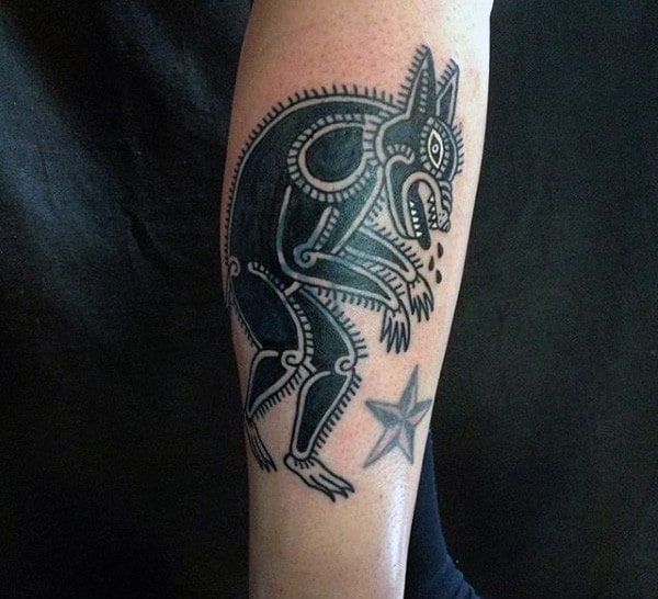 Male With Tribal Werewolf And Star Tattoo On Forearms