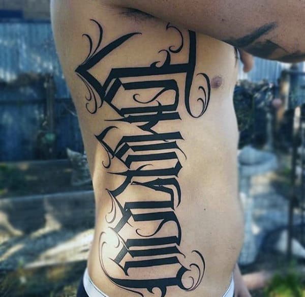 Males Torso Arabic Styled Lettering Tattoo