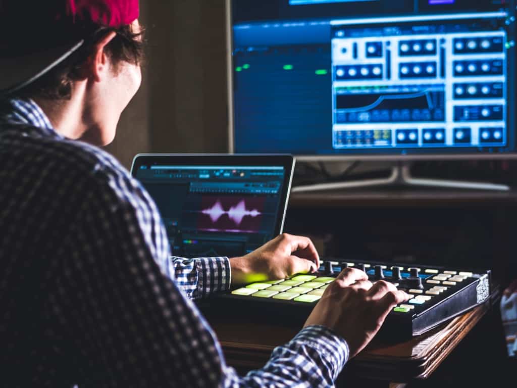 man creating music in studio with modern equipment
