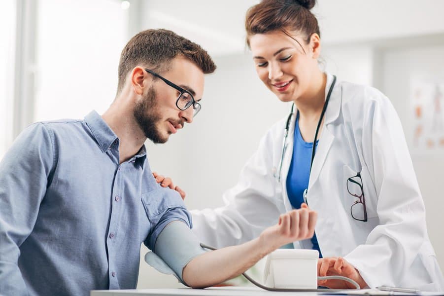 man having his blood pressure checked