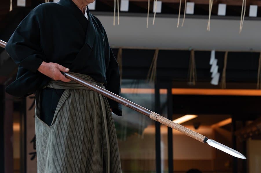 man holding japanese spear