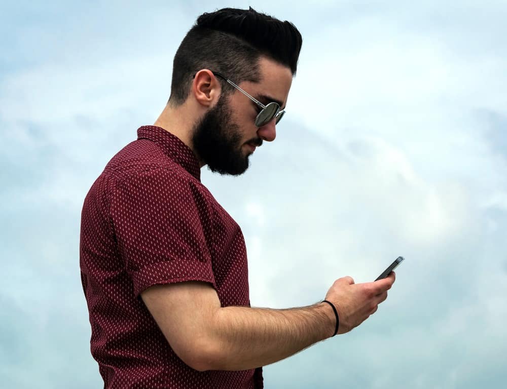 man outdoor texting