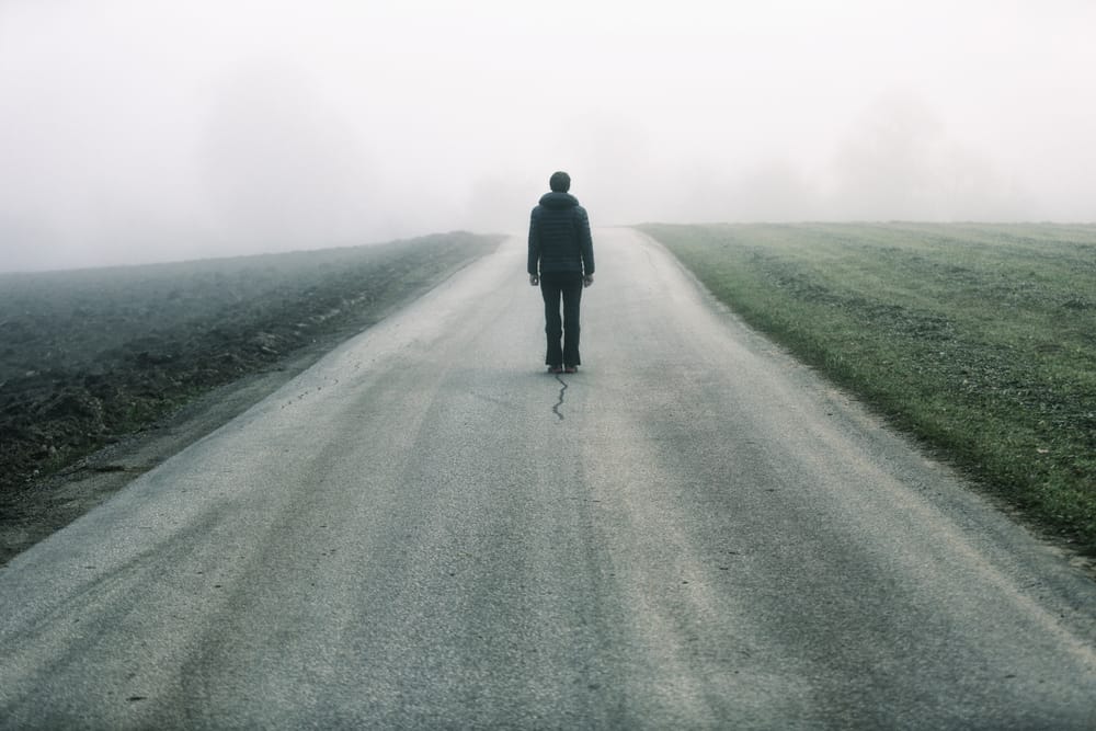 man standing alone on road