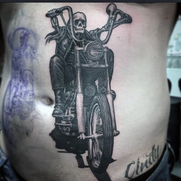 Man With A Tattoo Of Motorcycle On Ribcage Side