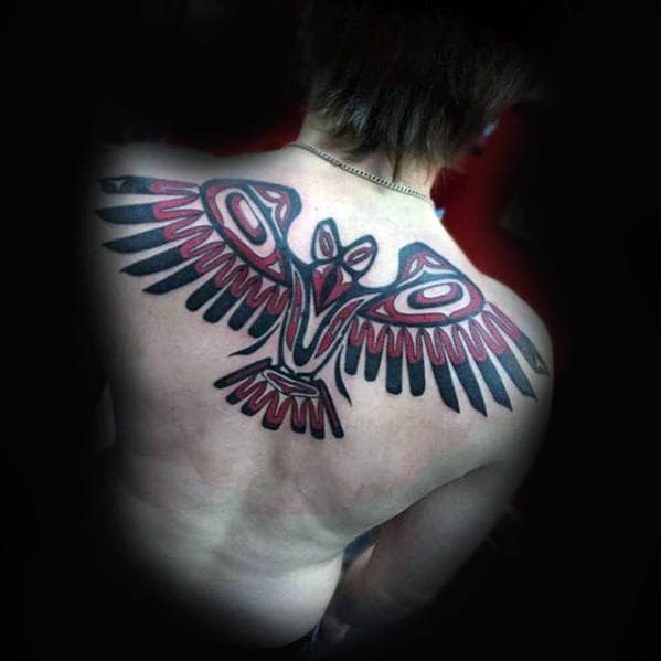 Man With Amazing Tribal Bird Red And Black Ink Back Tattoo