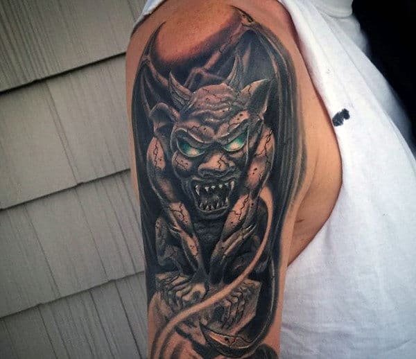 Man With Arm Tattoo Of Gargoyle With Glowing Green Eyes