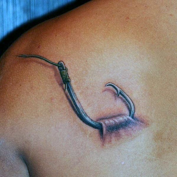Man With Back Tattoo Of Fish Hook Catching On Skin