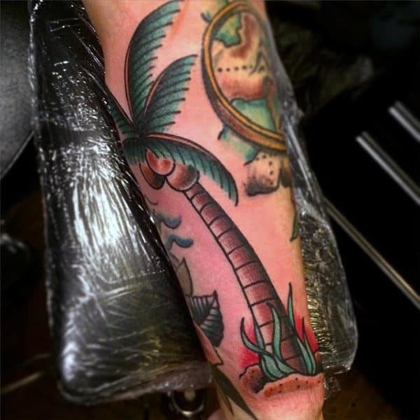Man With Beautiful Palm Tree Tattoo On Arms