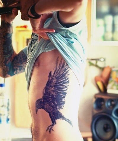 Man With Black Bird Tattoo On Ribs