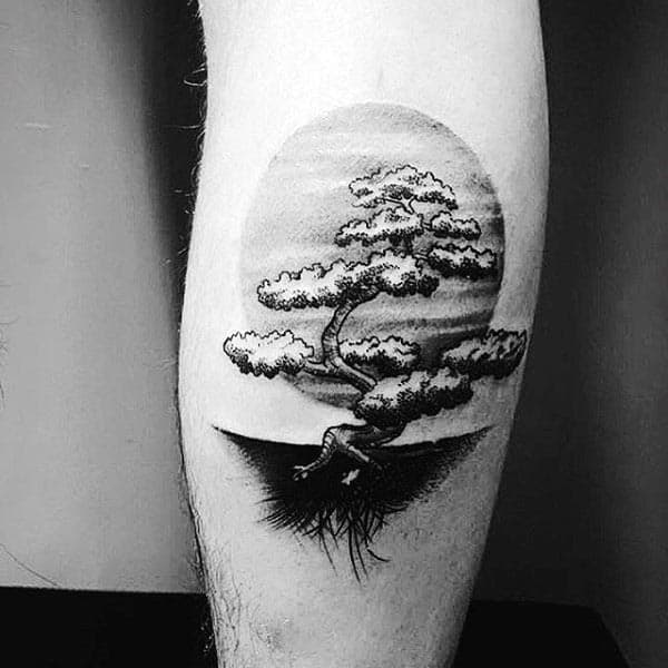 Man With Black Ink Shaded Bonsai Tree And Sun Tattoo On Leg