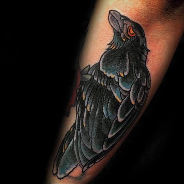Man With Blue And Black Traditional Crow Outer Forearm Tattoo