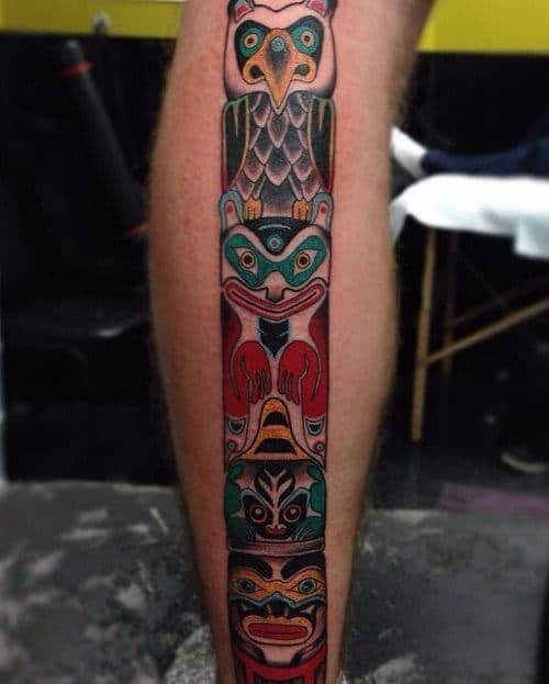Man With Brightly Colored Totem Pole Calf Tattoo