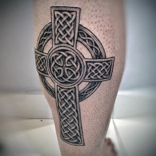 Man With Celtic Cross Tattoo Design On Back Of Leg Calf
