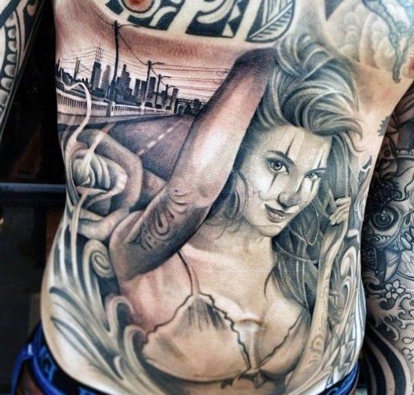 Man With Chicano Chest Tattoo Of Female And Road
