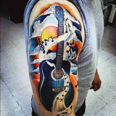 Man With Colorful Guitar Tattoo On Arm