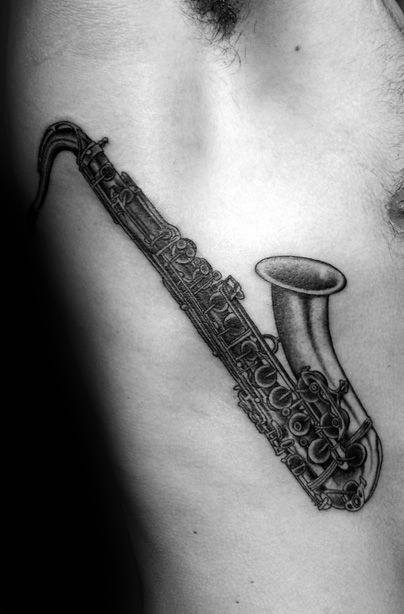 Man With Cool Saxophone Tattoo On Rib Cage Side Of Body