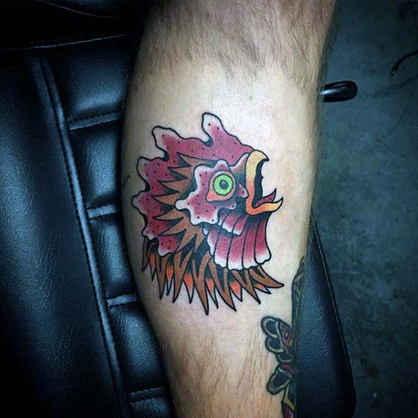 Man With Crowing Rooster Tattoo On Calf In Bright Colors