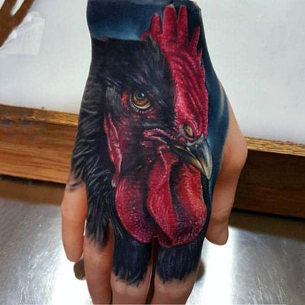 Man With Dark Realistic Rooster Tattoo On Hand