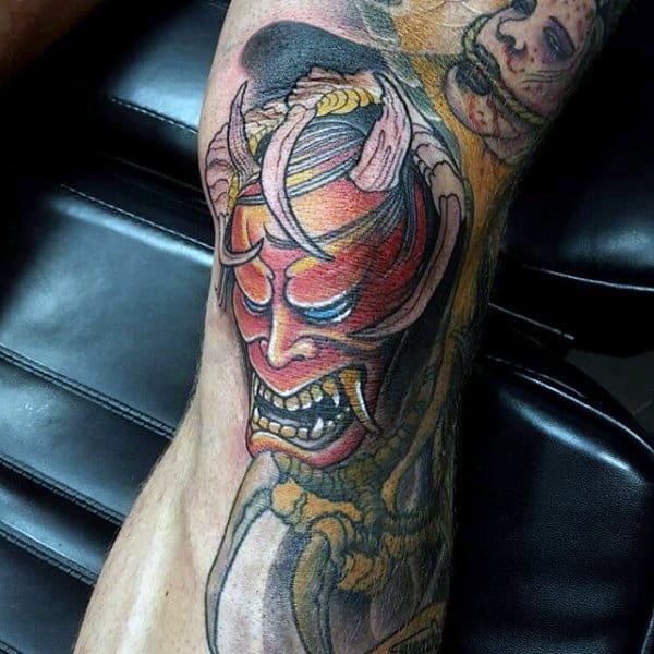 Man With Demon Mask Knee Tattoo Design