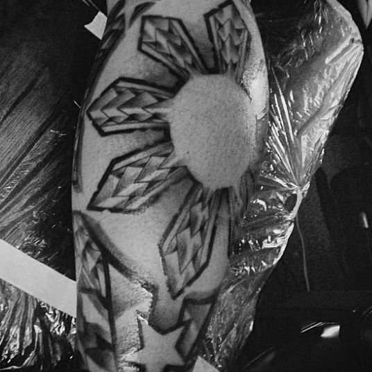 Man With Elbow Tribal Sun Polynesian Tattoo