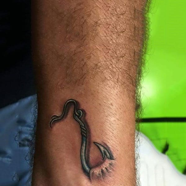 Man With Fish Hook Through Forearm Tattoo Design Inspiration
