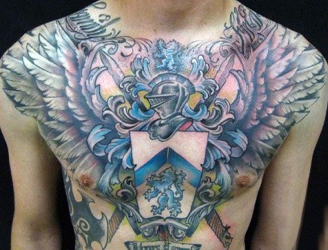 Man With Full Chest Family Crest Tattoo And Wings