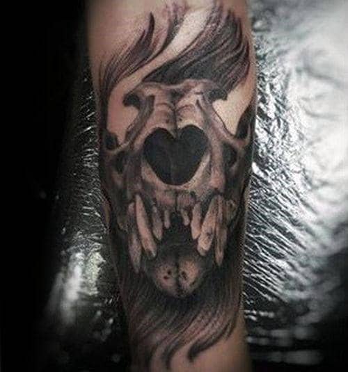 Man With Glowing Lion Skull Forearm Tattoo