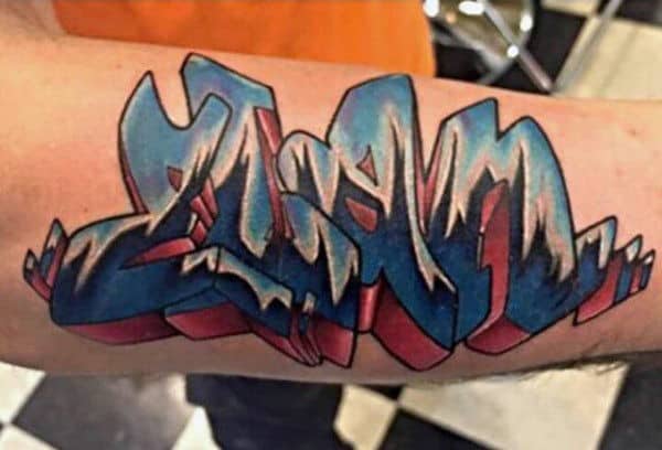 Man With Graffiti Tattoo Word On Arm