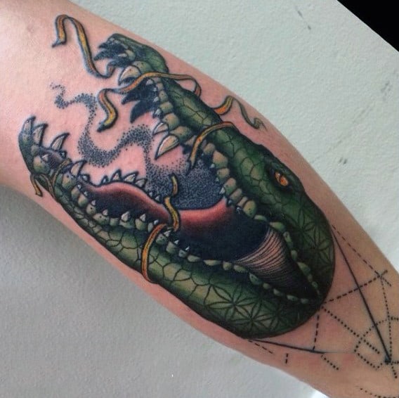 Man With Green Alligator And Snakes Tattoo On Arms