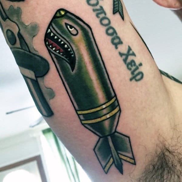 Man With Green Bomb Tattoo On Arms