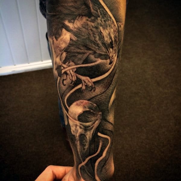 Man With Half Sleeve Hawk And Skull Shaded Tattoo
