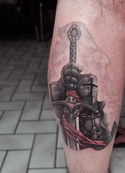 Man With Heroic Knight Themed Tattoos On Leg Calf