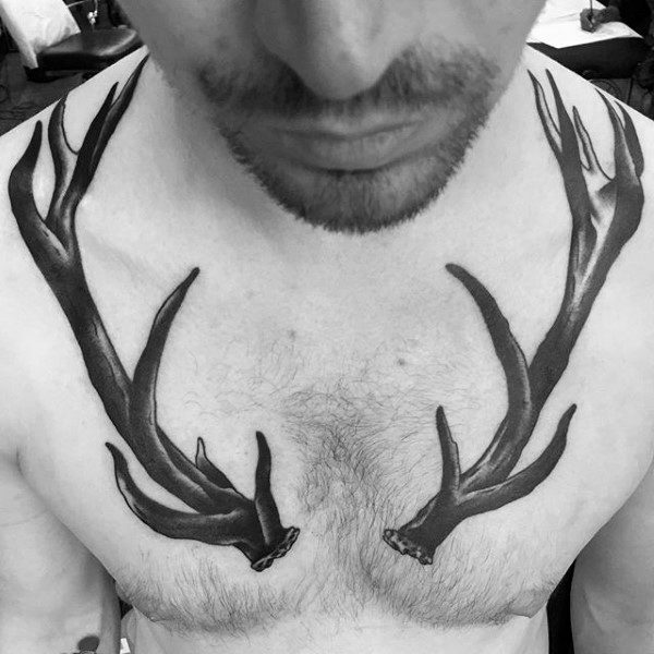 Man With Large Antler Chest Tattoos