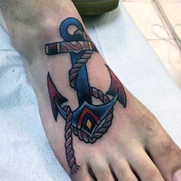Man With Navy Blue Anchor Tattooo On Foot