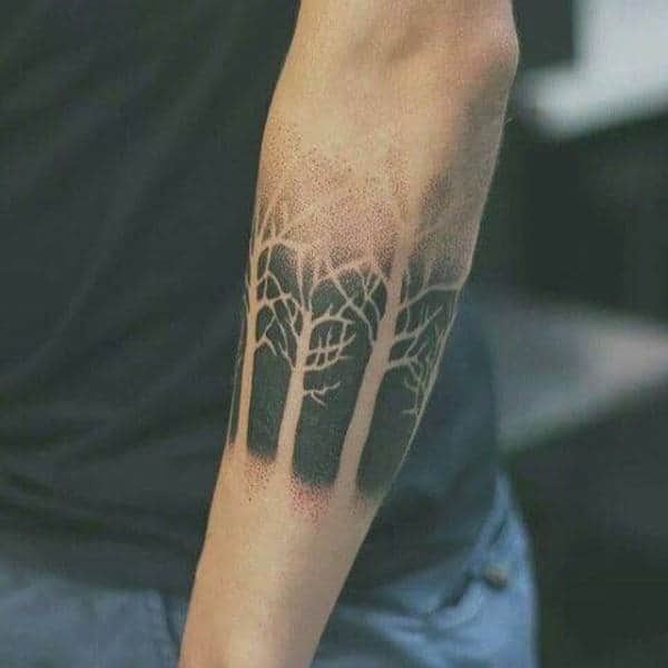 Man With Negative Space Black Ink Forearm Tattoo Of Trees