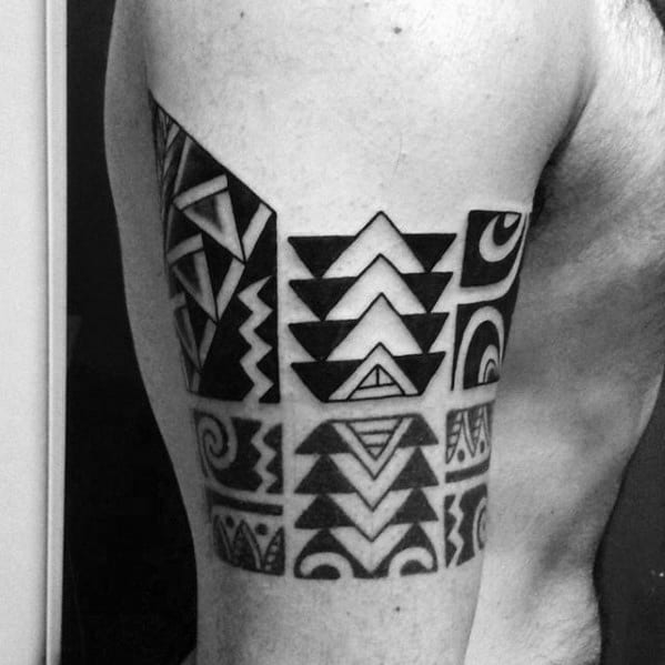 Man With Old School Tribal Armband Tattoo On Upper Arm