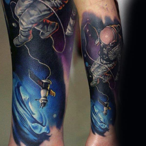 Man With Outer Space Sky Astronaut Tattoo On Forearm