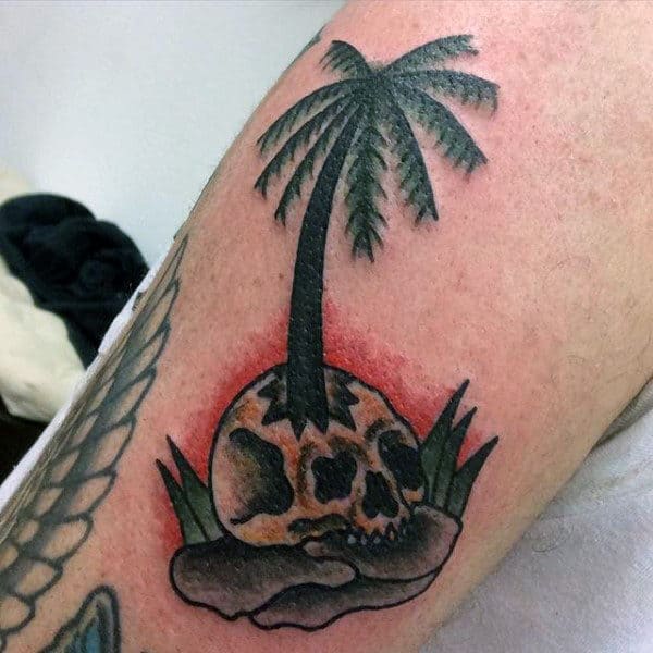 Man With Palm Tree And Skull Tattoo On Arms