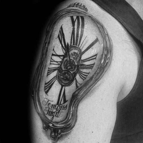 Man With Roman Numeral Melting Clock Upper Arm Tattoo