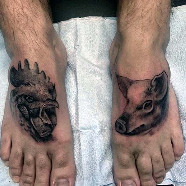 Man With Rooster Aand Pig Tattoos On Feet In Shaded Black Work
