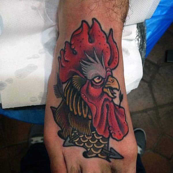 Man With Rooster Head And Arrows Tattoo On Foot