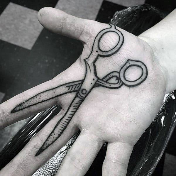 man-with-scissor-on-palm-tattoo